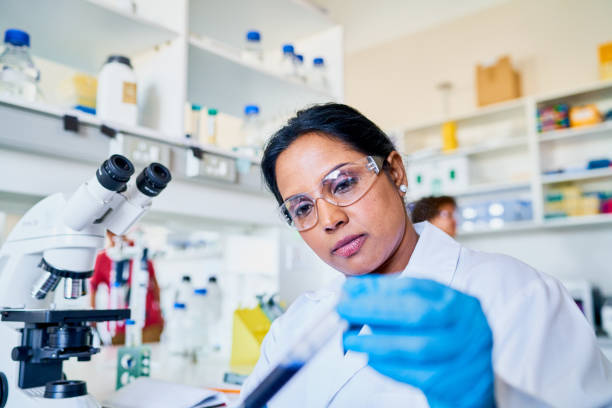 istock Scientist examining a sample in a test tube while working in a lab 1257413706
