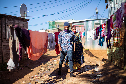 An African man and woman walking to work in Kayamandi informal settlement near Stellenbosch South Africa.