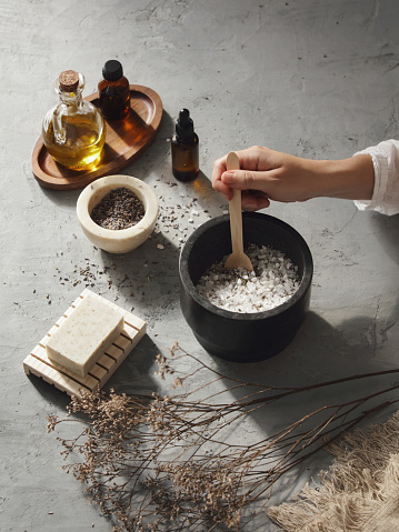 Woman making homemade bath salt with lavender