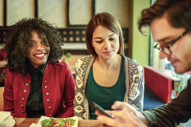 istock Diverse happy friends having fun sitting in cafe 1257415759