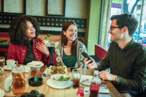 istock Diverse happy friends having fun sitting in cafe 1257415808