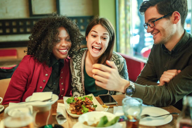 istock Diverse happy friends having fun sitting in cafe 1257415961