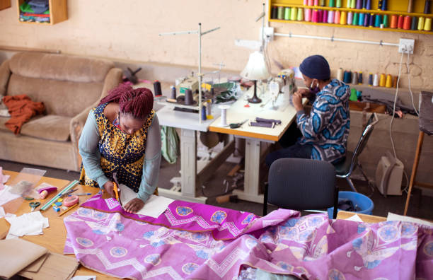 istock An African woman cutting patterns in fabric in her studio. 1257416047