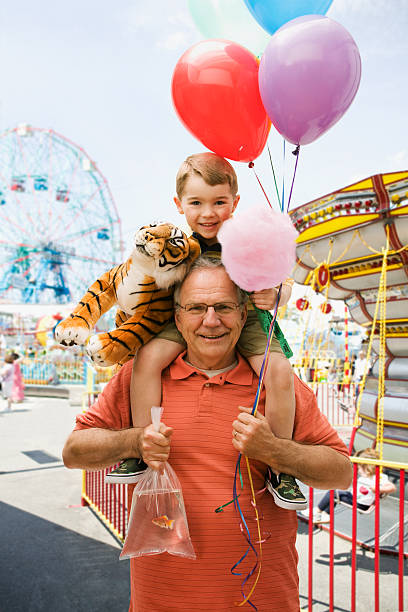 Portrait of a Grandfather and Grandson in a Fair West Newyork, NJ child cotton candy stock pictures, royalty-free photos & images