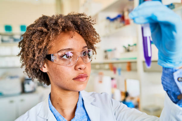 istock Young female scientist analyzing a test tube sample against the light 1257417158