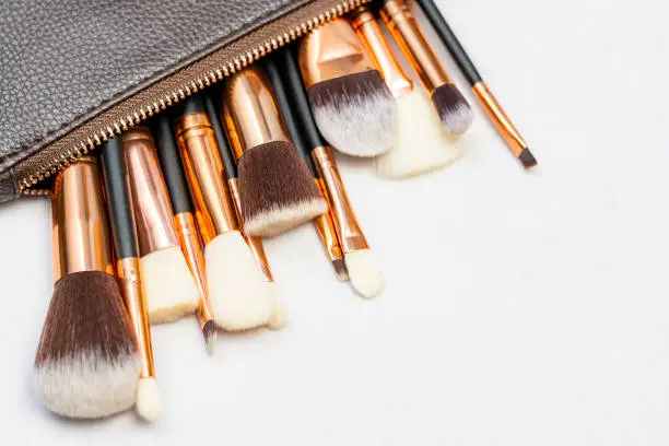 Photo of Makeup brushes in white background with copyspace