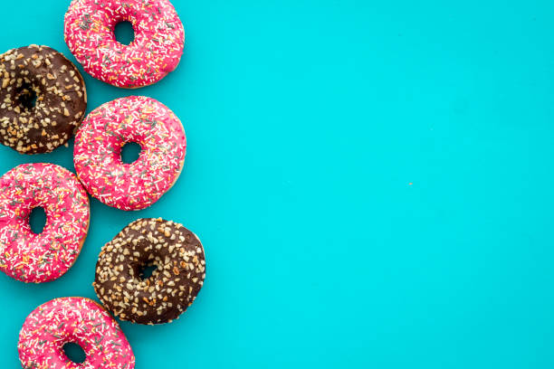 istock Top view of colorful glazed donut swith sprinkles, copy space 1257417396