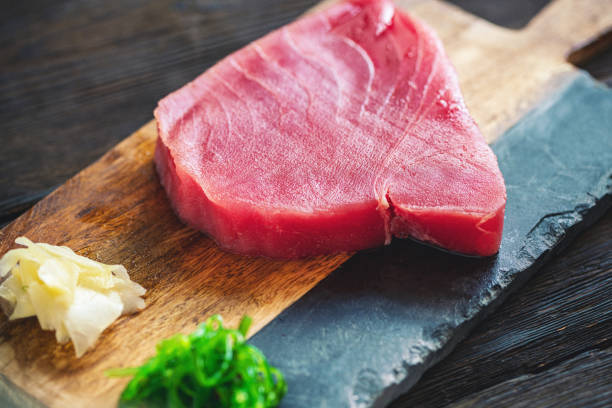 istock Raw Tuna Steak with ingredients on a cutting board 1257419689