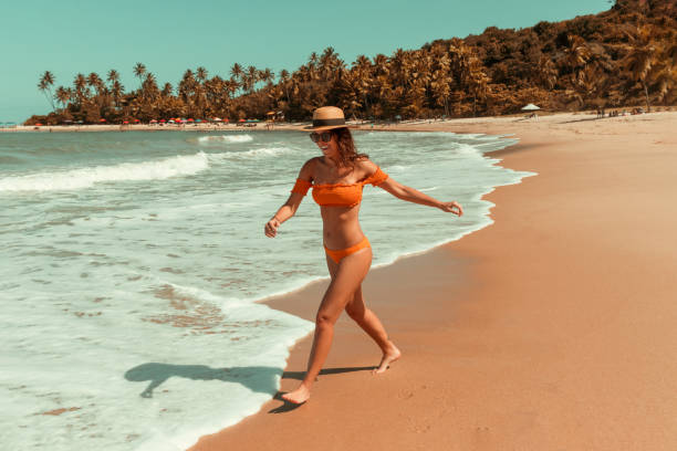 istock Girl running at the beach 1257420541