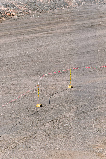 istock warning tape on gravel red white 1257421244