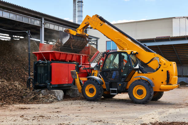 istock bucket loader loads tree bark into an industrial woodchipper 1257421890