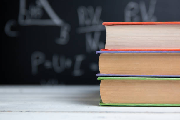 istock School books on white table on blackboard background 1257422336
