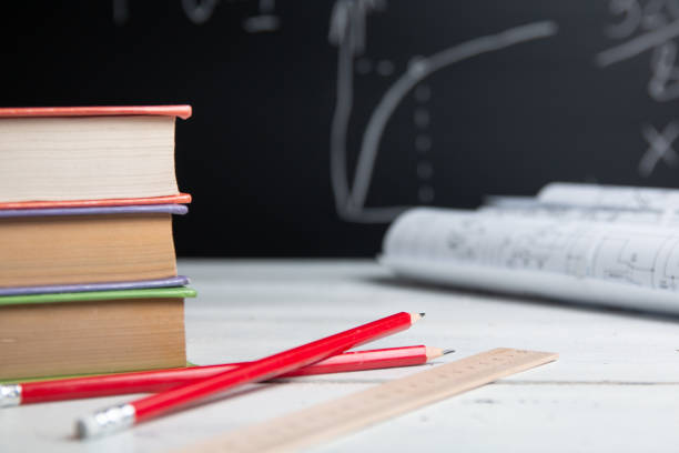 istock Education concept. Books and pencils on blackboard background 1257422367