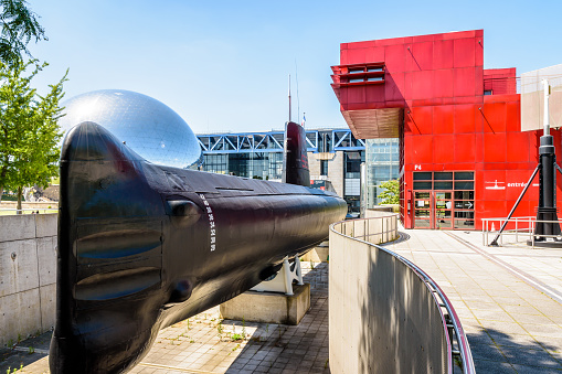 Paris, France - June 22, 2020: General view of the Argonaute (S636) submarine, converted to a museum ship in 1991, next to La Geode geodesic dome and the Cite des Sciences et de l'Industrie.
