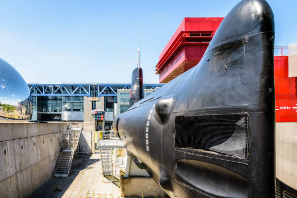 Bow of the Argonaute submarine and La Geode in front of the Cite des Sciences et de l'Industrie in Paris, France. Paris, France - June 22, 2020: The bow with torpedo tubes of the Argonaute (S636) submarine, converted to a museum ship in 1991, next to La Geode dome and the Cite des Sciences et de l'Industrie. la geode stock pictures, royalty-free photos & images