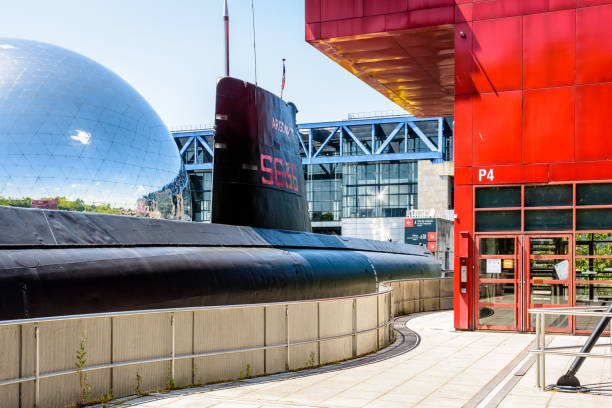 The Argonaute submarine and La Geode in front of the Cite des Sciences et de l'Industrie in Paris, France. Paris, France - June 22, 2020: The Argonaute (S636) submarine was converted to a museum ship in 1991 and installed next to La Geode dome in front of the Cite des Sciences et de l'Industrie. industrie stock pictures, royalty-free photos & images