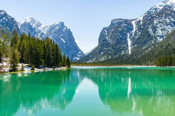 istock Reflections on Dobbiacco Lake, Dolomites mountains, Italy 1257425522