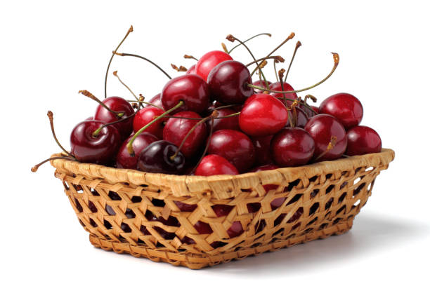 istock Sweet organic cherry berries in a wicker basket, white background, close-up. 1257425733