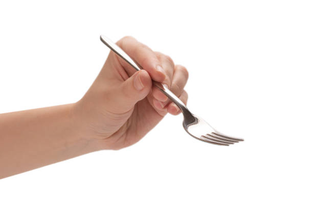 istock Fork in woman hand isolated on white. 1257425839