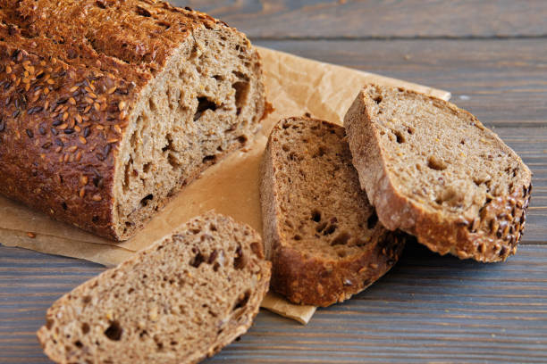 istock Rye and wheat bread with sunflower seeds on a wooden table 1257426484