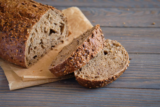 istock Rye and wheat bread with sunflower seeds on a wooden table 1257426494