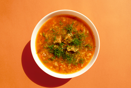 Green peas and beef meat, a healthy protein lunch after the workout, made of beef meat, green peas, potatoes, carrot and garlic, served in a modern plate on a rustic wooden home or restaurant table, representing a wellbeing and a healthy lifestyle, an image with a copy space