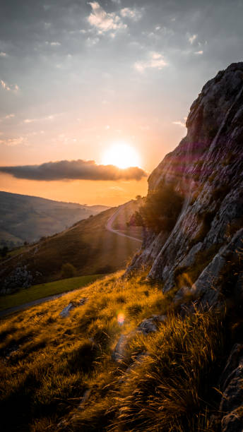 istock sunset with mountain on the right and road 1257426939