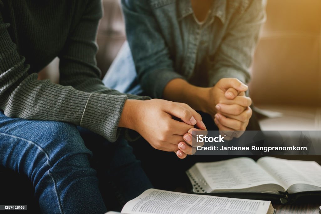 two women reading and study bible  in home and pray together. Bible Stock Photo