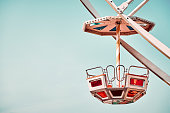 Close up picture of Ferris wheel car with cloudless sky in background.
