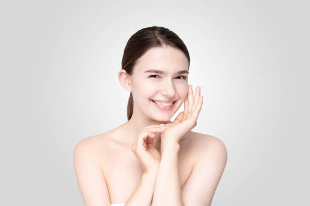istock Asian young woman touching face with relaxed expression 1257429673