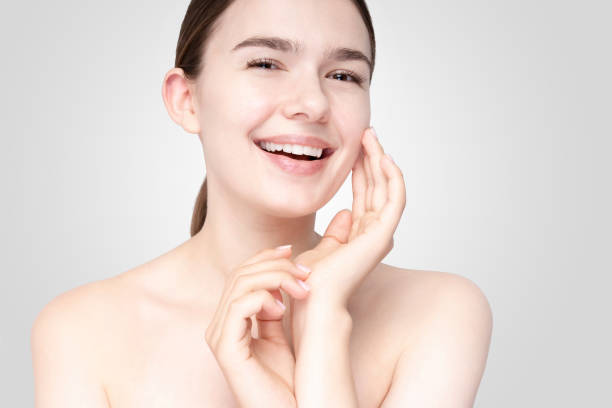 istock Asian young woman touching face with relaxed expression 1257430208