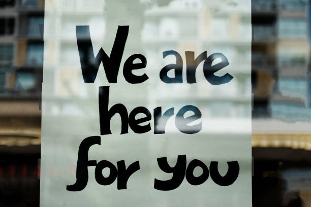 We Are Here For You Sign on Window of Business North Vancouver, British Columbia, Canada. emotional support stock pictures, royalty-free photos & images