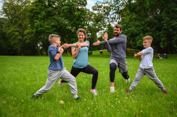 istock Family doing stretching exercises in nature. 1257430500