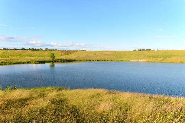 A small reservoir in a ravine on a summer evening