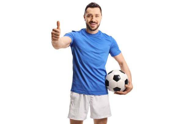 istock Soccer player holding a ball and giving a thumb up 1257430802