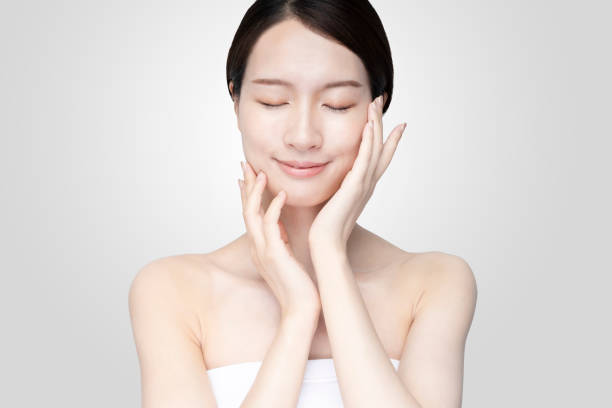 istock Asian young woman touching face with relaxed expression 1257430971