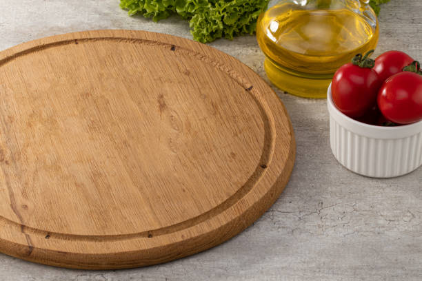 istock empty wooden cutting board on stone table top view 1257431832