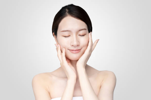 istock Asian young woman touching face with relaxed expression 1257432166