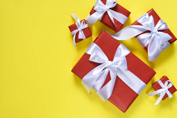 istock Red boxes with a white ribbon on a yellow background.