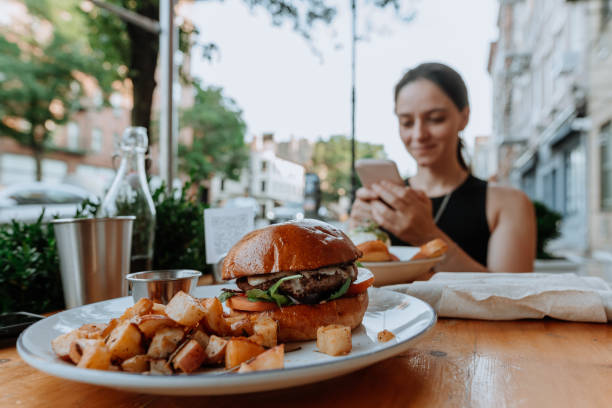 istock Woman eating vegan hamburger 1257434992