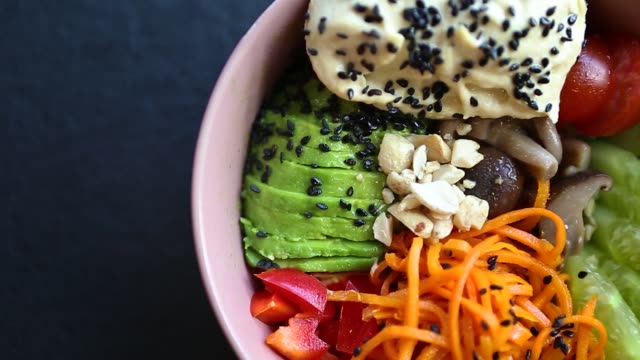 Poke bowl for healthy breakfast meal filmed in flat lay style directly from above in panoramic moving video clip.