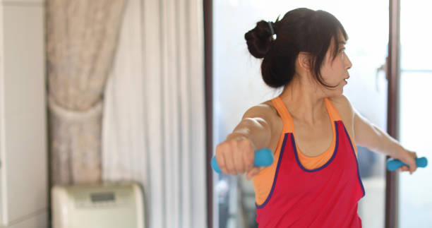 istock Woman exercise at home 1257437303