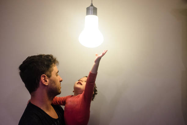 istock Father and Son Playing with a Lamp 1257439943
