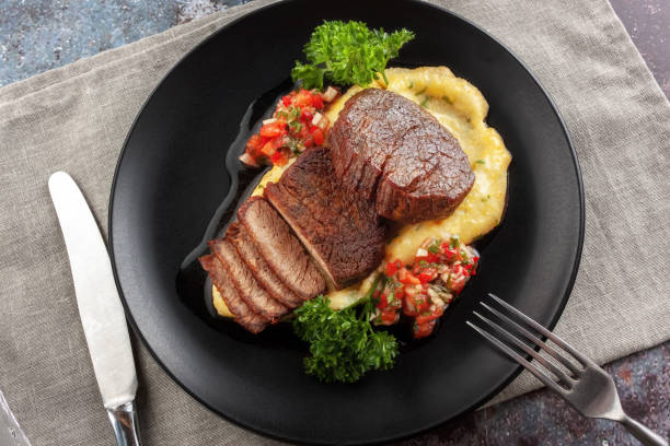 istock Beef medallions with tomato salsa and cream polenta 1257439945