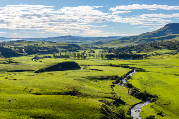 istock Mountain stream snake through green pastures in the valley below 1257440988