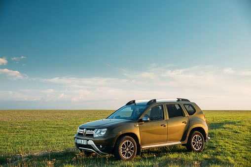 Gomel, Belarus - May 6, 2020: Renault Duster SUV In Spring Field Countryside Landscape. Duster Produced Jointly By French Manufacturer Renault And Its Romanian Subsidiary Dacia