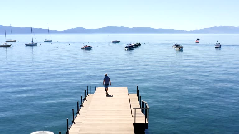 Man Walking along Pier at Lake Tahoe