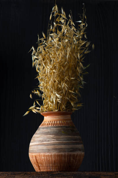 istock Old clay vase with a sheaf of oats. 1257445065