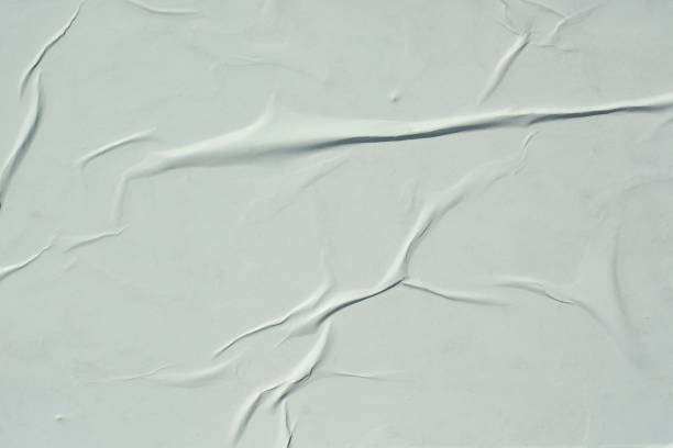 istock A sheet of white crumpled paper. Abstract background for design. 1257445091