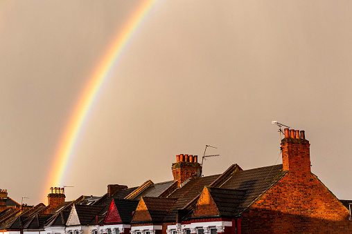 Rainbow appearing over houses in London.